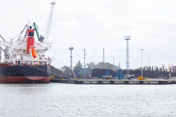 Fototapeta premium coal unloading in polish shipyard, coal shortage Mountains of coal on the territory of the Poland Commercial Sea Port. The unloading of wagons 