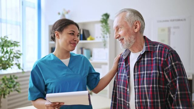 Senior man vising physician in rehabilitation center, treatment plan, healthcare