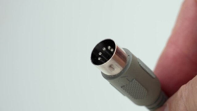5-Pin stereo cable with DIN standard plug. Analog connector in hand close up