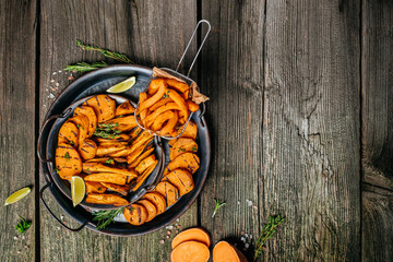 Sweet potatoes fries with lime and herbs yogurt sauce. banner, menu, recipe place for text, top view