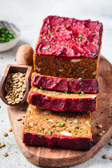 Lentil vegan meat oaf sliced on wooden board. Christmas recipe.