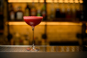 front view on wine glass full of signature cocktail with tomato juice. Copy space