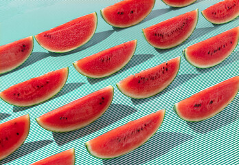 Repeating water melon slices pattern on stiped background