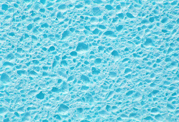 Light blue color porous cleaning sponge texture as background