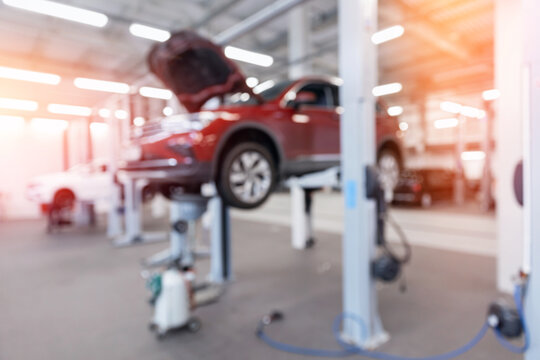 Blurred background change motor oil car in auto service garage