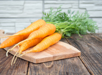 Fresh and sweet carrots on an old wooden table