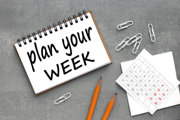 Plan Your Week text on notebook page on gray background