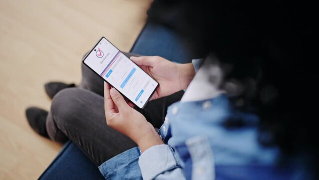 Top view of young woman voting on smartphone, using app for online voting