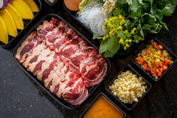 Beef shabu and vegetables on a tray on the table