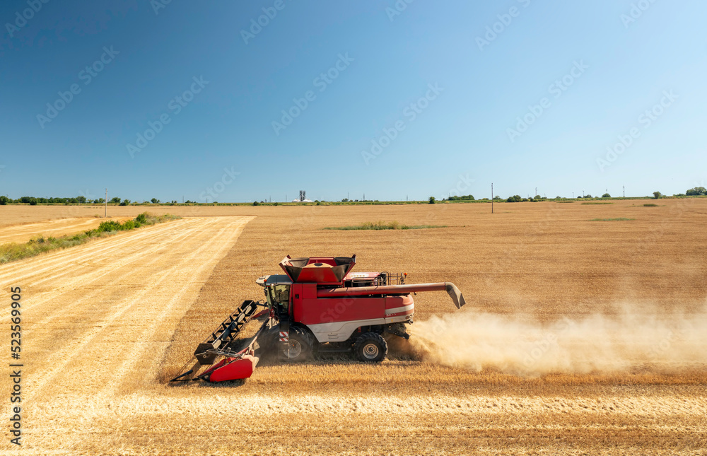 Aufkleber Combine harvester in action on wheat field.
