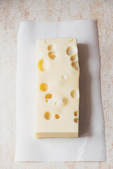 French emmental semi-hard cheese, close up, selective focus.