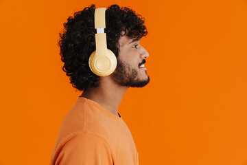 Close-up profile of young indian smiling man in headphones