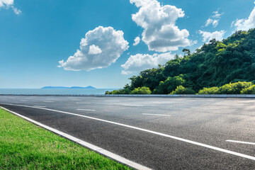 Asphalt and green mountains by the sea