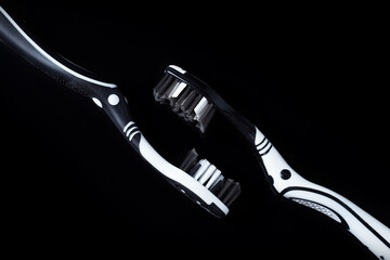 black and white toothbrushes isolated on a black background