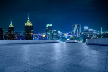 Empty floor and city skyline with modern building in Suzhou at night, China.