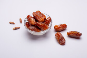 Bowl of pitted dates isolated on white background, top view
