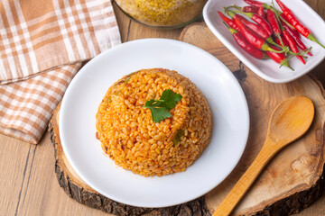 Traditional turkish bulgur pilaf with tomato sause in plate (Turkish name; meyhane pilavi)