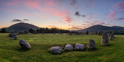 Pink and purple sunrise with a panoramic view of Castlerigg Stone Circle, Keswick, Lake District,...