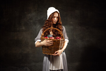 Vintage style. Young charming redhair girl with long curly hair like girl of renaissance eras...