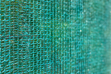 Knitted polyethylene mesh background, sun protection material that creates shade danger of solar...