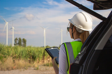 engineer team working in wind turbine farm. Renewable energy with wind generator by alternative energy concept.