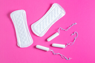 Menstrual tampons and pads on a pink background. Menstruation cycle. Hygiene and protection.
