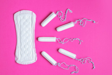 Menstrual tampons and pads on a pink background. Menstruation cycle. Hygiene and protection. copy space