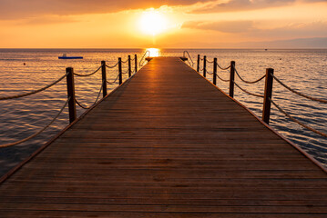 sunset pier in the sea 