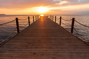 sunset pier in the sea 