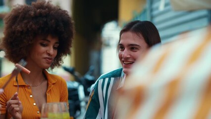 Multiethnic group of friends going out after school and having fun. Celebrating with aperitif cocktails and food in a nice bar