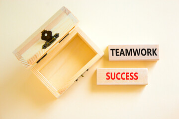 Teamwork success symbol. Concept words Teamwork success on wooden blocks on a beautiful white table white background. Empty wooden chest. Business and teamwork success concept. Copy space.