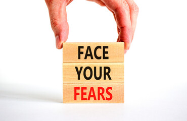 Face your fears and support symbol. Concept words Face your fears on wooden blocks. Businessman hand. Beautiful white table white background. Business and Face your fears quote concept. Copy space.
