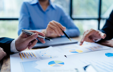 business partnership coworkers analysis strategy with discussing a financial planning graph and company budget during a budget meeting in office room.