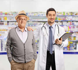 Doctor and an elderly male patient standing in a pharmacy