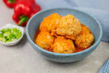 meatballs in a plate with onions and gravy