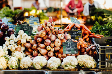 Onions and cauliflower and other fresh produce and vegetables at Farmers Market in Strasbourg, Alsace, France - 523592527