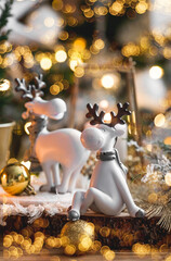 Happy New Year 2023. Christmas card with cute reindeer on a beautiful bokeh background. New Year's...