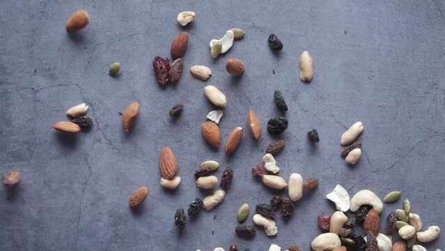 Top View Of Many Mixed Nuts Falling On Black Background 