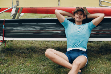 Sportsman european single scull man rower portrait sitting relaxing after training competition...