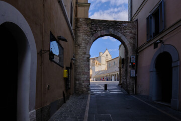 Fototapeta na wymiar Gate to the complex of theBasilica of Saint Francis of Assisi (basilica di San Francesco in Assisi) in the ancient town of Assisi, Umbria, Italy 