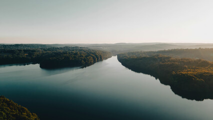 Aerial Photo of a large river surrounded by lush forests in New York. 