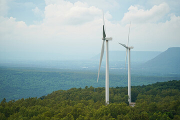 Windmills wind turbines farm power generators. Production of renewable green energy