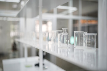 Health care researchers working in life science laboratory. Young female research scientist and senior male supervisor preparing and analyzing microscope slides in research lab.