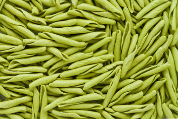 Food background. Green trofie pasta with spinach from Liguria. Short twisted pasta