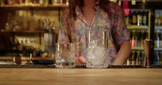 Bartender making drinks in warm bar