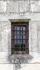 Fototapeta na wymiar a window with bars on the old castle is shot close-up