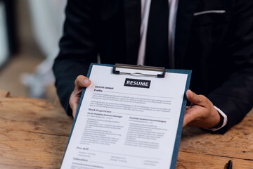 Executive reading an hr audit resume during a job interview and businessman Completing Application Form. Hiring and selection of human resource for the company.