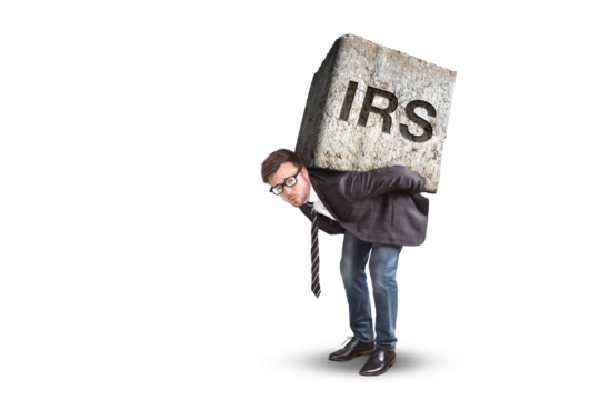 Businessman carrying a heavy stone with the letters IRS on it