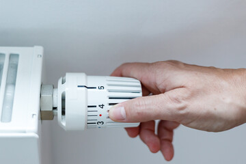 Hand adjusting temperature control in radiator