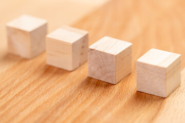 Wooden cubes in a row on a wood background. Toy blocks
